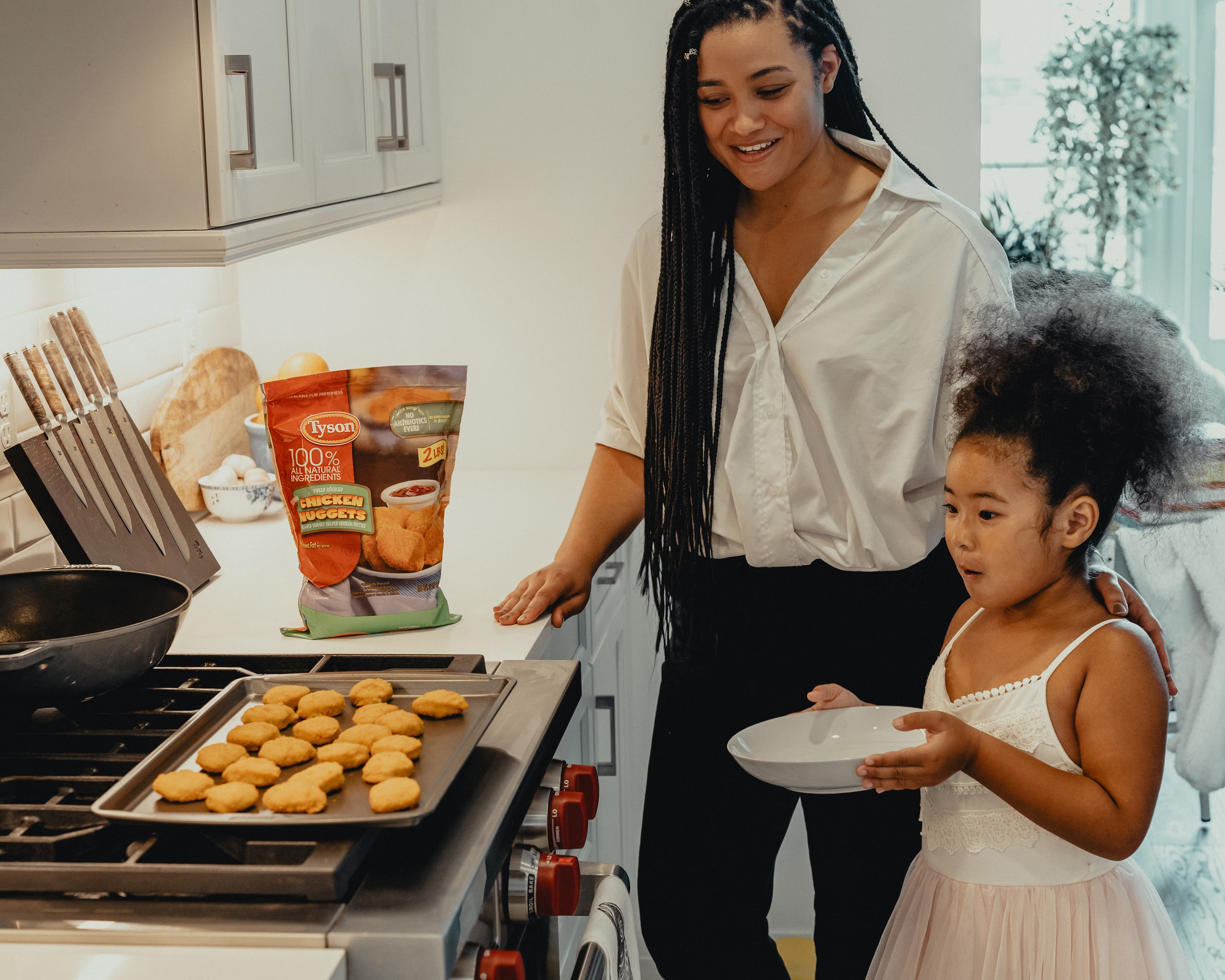 A mother and her daughter baking in the program